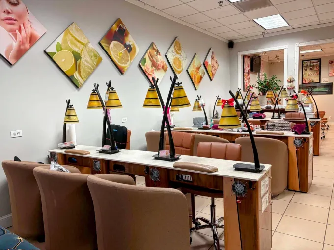Manicure stations beneath framed citrus artwork